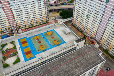 Aerial view of playground by buildings in city