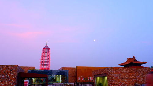 Low angle view of buildings against sky during sunset