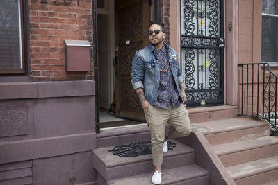 A young man on a doorstep.