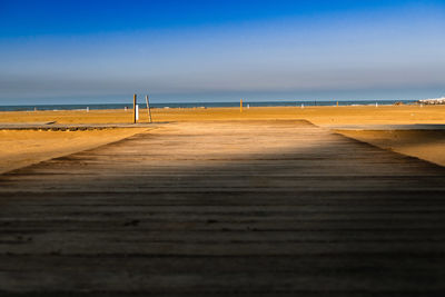 Scenic view of beach against blue sky