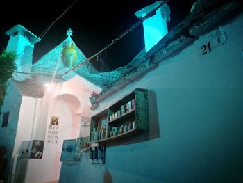 Low angle view of illuminated lanterns hanging outside building