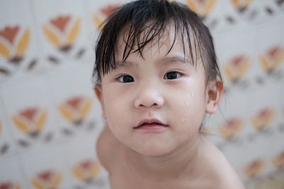 Close-up portrait of cute boy at home