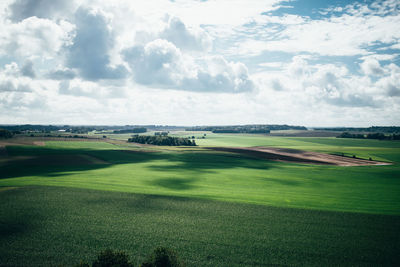 Scenic view of golf course against sky