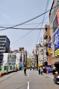 City street and buildings against sky