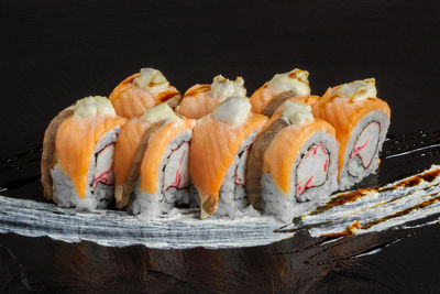 Close-up of sushi on black background