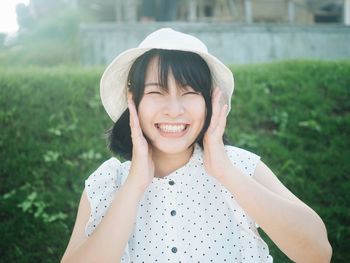 Portrait of a smiling young woman in field