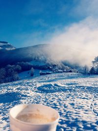 Scenic view of snow covered mountains against sky