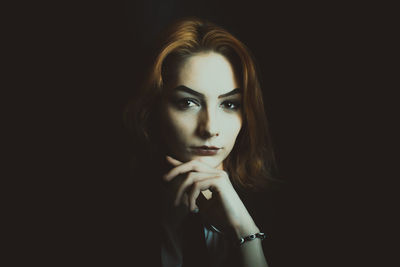 Portrait of girl against black background