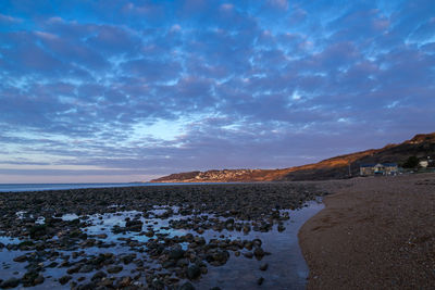 Scenic view of beach against sky during sunset