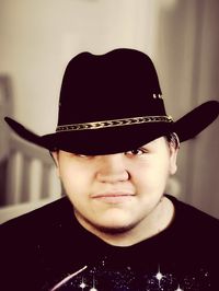 Close-up portrait of young man wearing hat