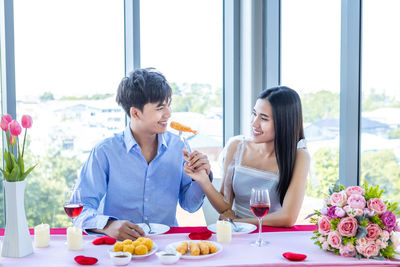 Young couple sitting on table