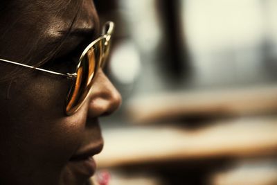 Cropped image of mid adult woman wearing sunglasses