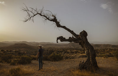 Adult man standing on desert during sunset. almeria, spain