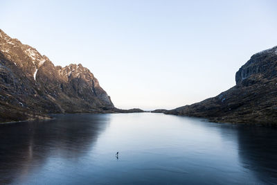 Man paddleboarding on lake