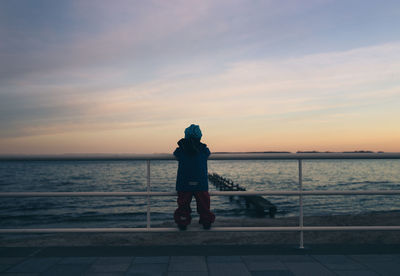 Rear view of man standing at beach