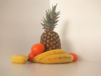 Close-up of fruits on table against white background