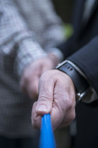 Close-up of man holding hands