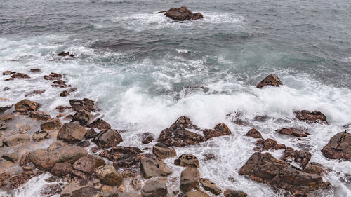 High angle view of rocks in sea