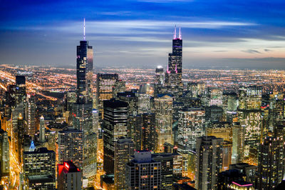 Aerial view of city lit up at night