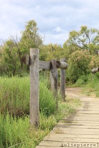 Wooden structure on field against sky