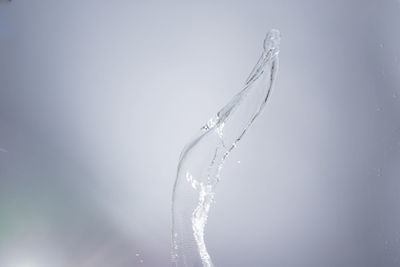 Close-up of water falling against white background