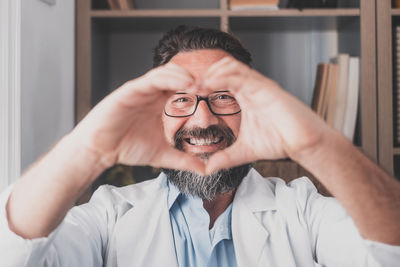 Portrait of man wearing eyeglasses at home