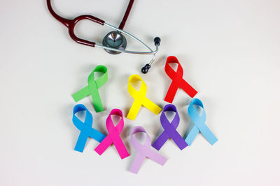 High angle view of multi colored toys on white background