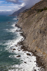 Scenic view of pacific ocean and mountains against highway 1 horizon.