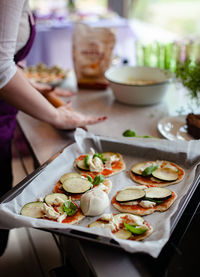 Midsection of woman having food in plate