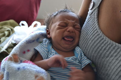 Close-up portrait of happy young woman lying down