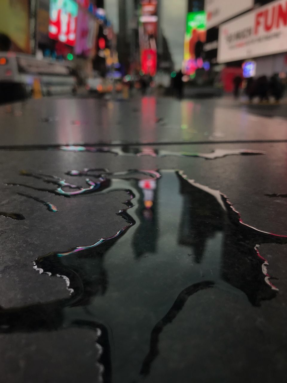 REFLECTION OF CITY ON WET ROAD