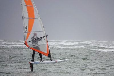 Sailboat on sea against sky