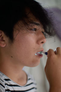 Close-up of man brushing teeth