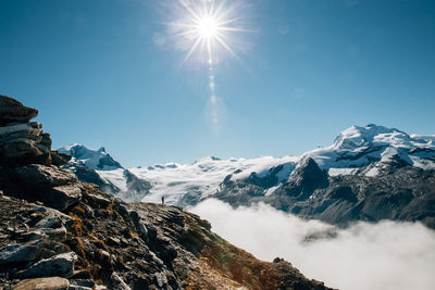 Scenic view of snowcapped mountains against clear sky