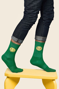 Low section of man standing against white background