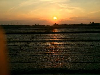 Scenic view of sunset over land