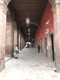 People walking in corridor of building