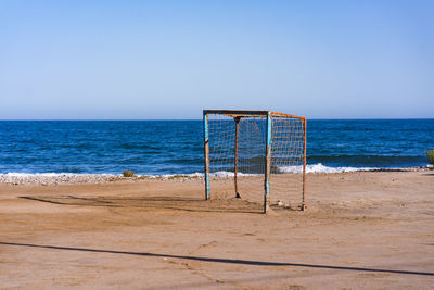 Lifeguard hut on beach against clear sky