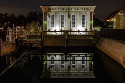 Reflection of illuminated buildings in city at night