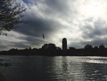 River in city against cloudy sky