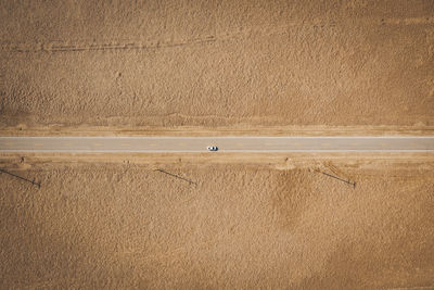 A lonely road through the californian desert from above