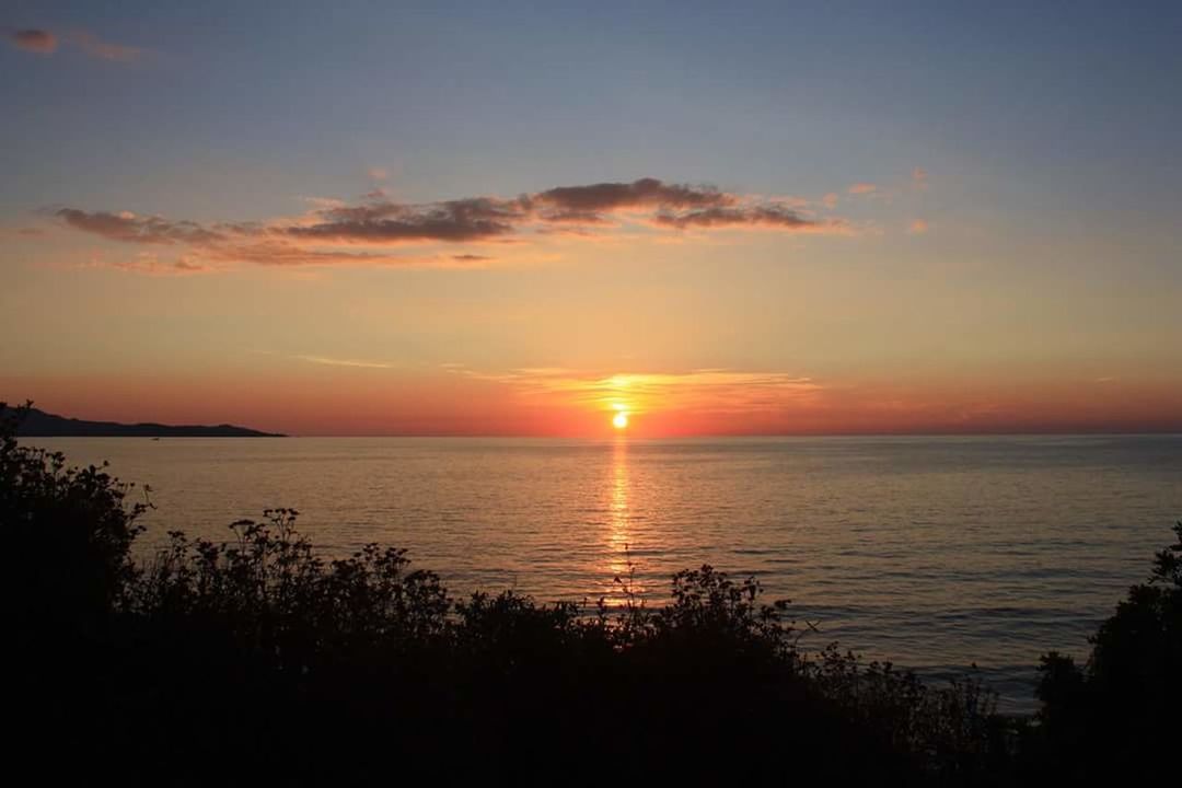 SCENIC VIEW OF SEA AT SUNSET