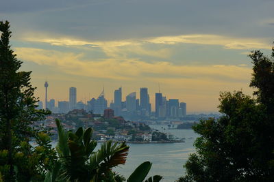 Scenic view of city buildings against sky during sunset