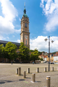 View of clock tower amidst buildings in city