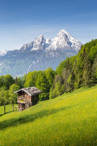 Scenic view of field and mountains against sky