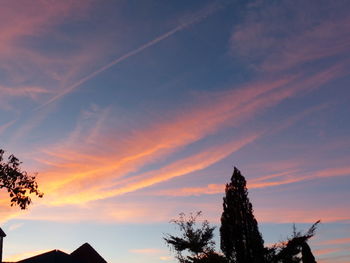 Low angle view of silhouette trees against sky at sunset