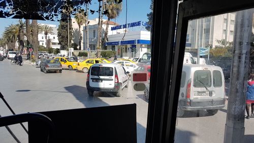 Traffic on road by buildings in city