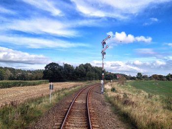 Railroad track on grassy field