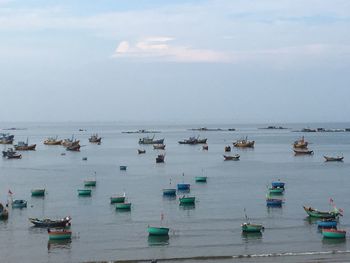 High angle view of boats moored in sea against sky