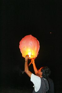 Low angle view of lit lamp